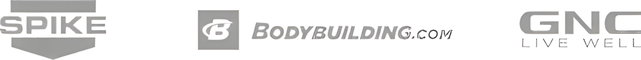 The image shows three logos in a row from left to right: SPiKE, bodybuilding.com, and GNC Live Well. All logos are gray, with SPiKE and GNC in uppercase letters. The logo for bodybuilding.com includes a stylized "B" with a muscular arm at the center, embodying Dr. Stoppani's dedication to fitness goals.